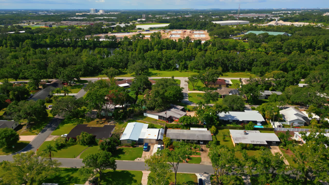 Drone pullback descend above residential neighborhood with abundant greenery in Tampa, Florida