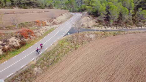 Cyclists-riding-through-winding-roads-in-Montserrat-and-Marganell-Mountains-Barcelona