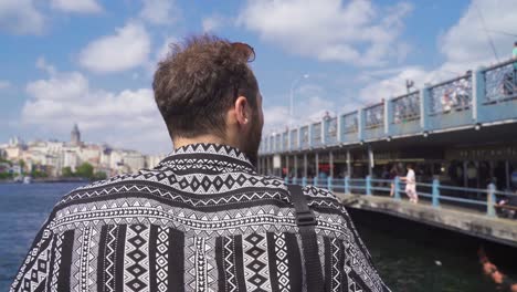 Young-man-watching-the-sea-on-a-sunny-Istanbul-day.