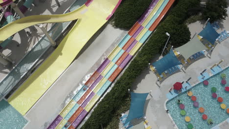 tourists splash to stop after riding tall water slide in sunny bahamas