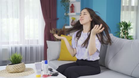 Asian-teenage-girl-combing-her-unkempt-and-dry-hair.