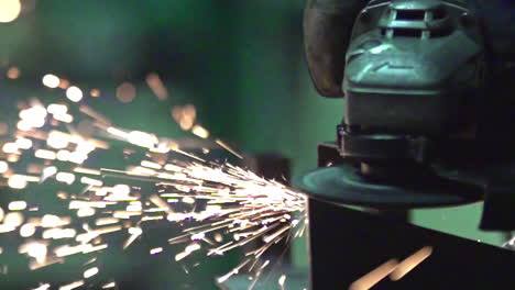 Cutting-metal-up-close-with-angle-grinder-disc-power-tool,-sparkles