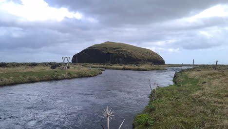 river, volcanic hill and pastures, landscape of iceland