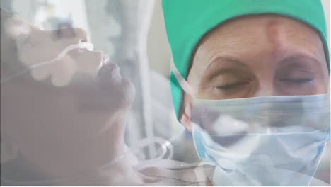 Portrait-of-caucasian-female-surgeon-wearing-face-mask-against-senior-woman-in-hospital-bed