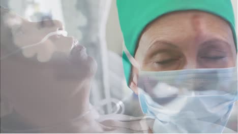 portrait of caucasian female surgeon wearing face mask against senior woman in hospital bed