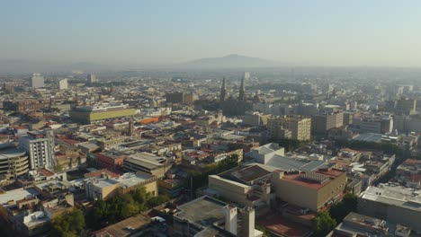 drone approaches guadalajara cathedral , mexico. smog. hazy