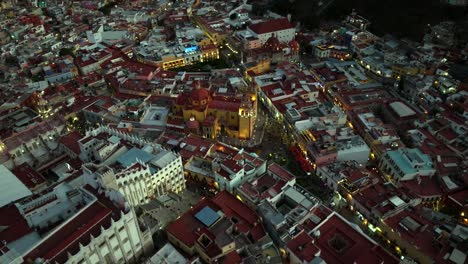 drone: orbit of downtown guanajuato at dusk