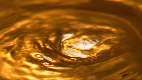 boiling liquid gold with ice cubes