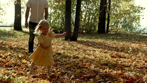 family playing catch in autumn park