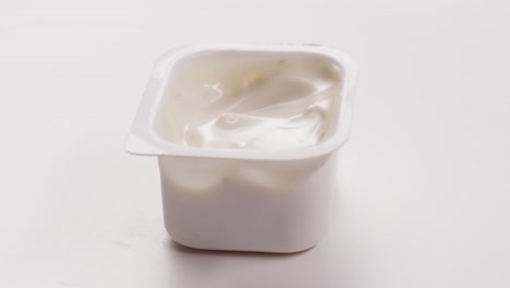 single-serving white sauce in plastic container