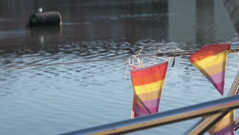 Sailing-boat-moored-it's-ropes-and-flags-on-a-calm-winter-sunny-day-in-Ireland