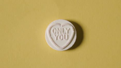 heart candy with only you message on yellow background