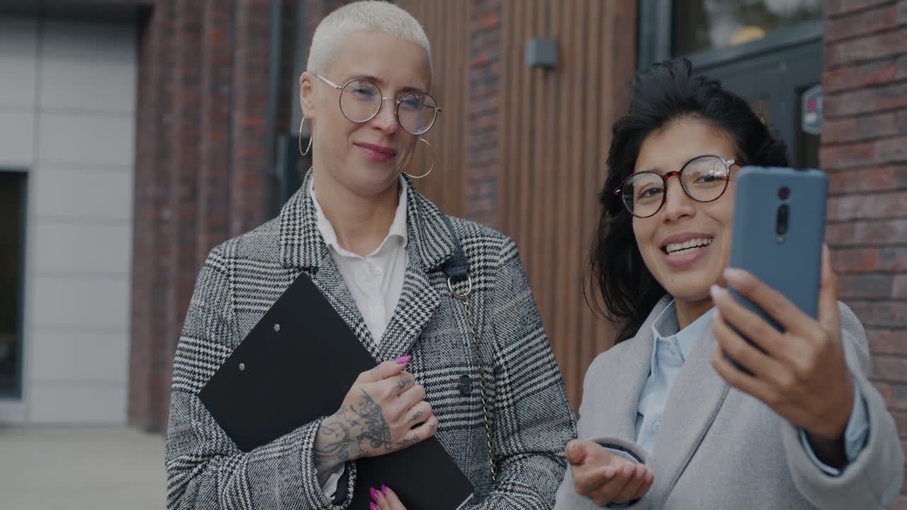 Two Businesswomen Having a Video Call Outdoors