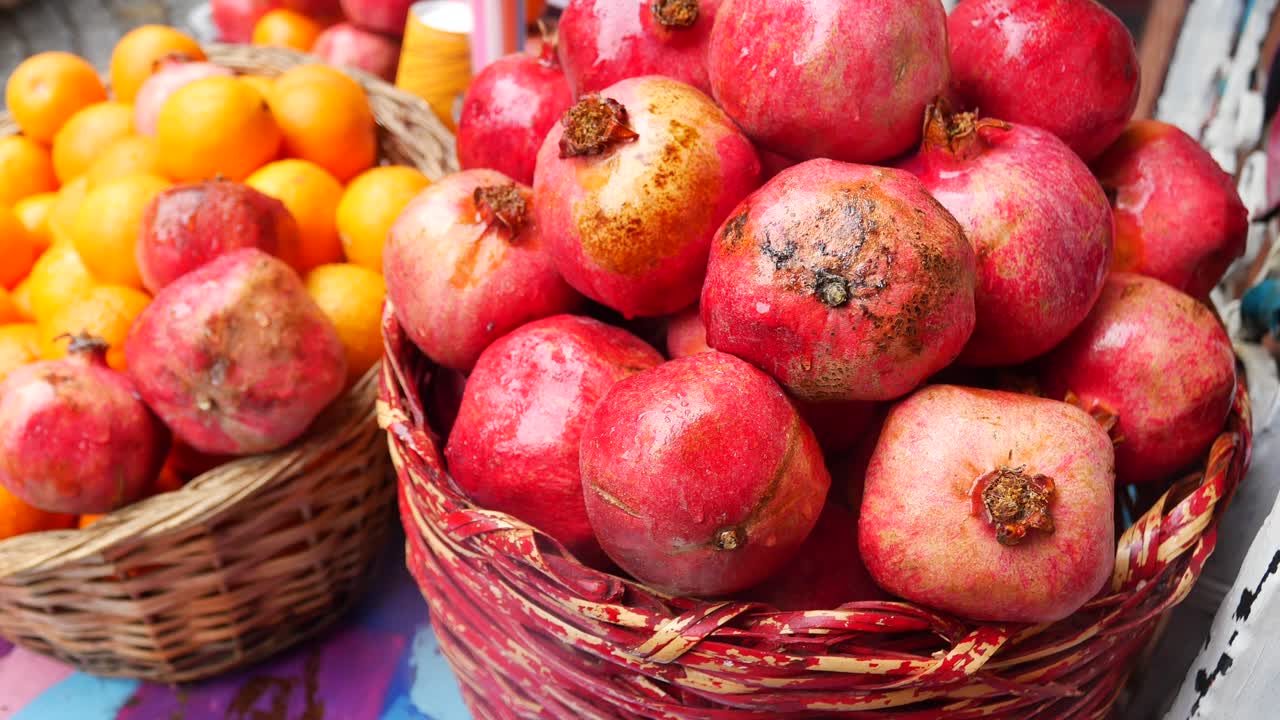 Baskets of fresh pomegranates and oranges
