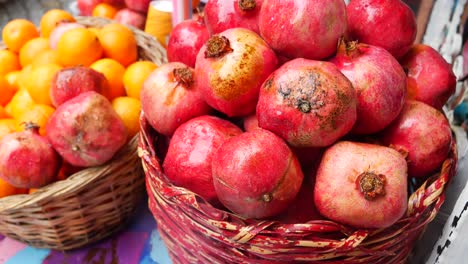 baskets of fresh pomegranates and oranges