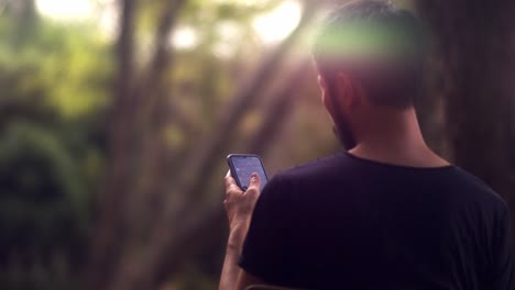 Cinematic-shot-of-male-asian-model-looking-for-a-message-on-his-smartphone-by-scrolling