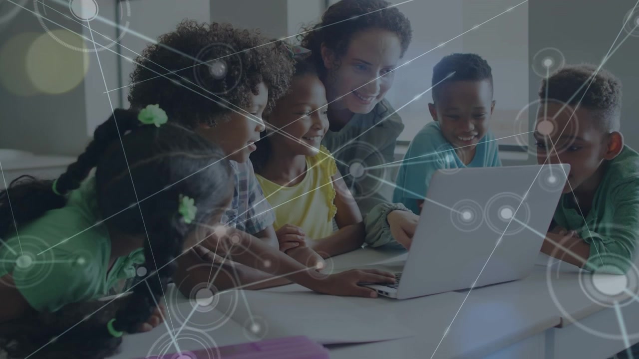 Teacher and Students Using Laptop in Classroom with Digital Network Overlay