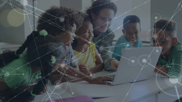 Teacher and Students Using Laptop in Classroom with Digital Network Overlay