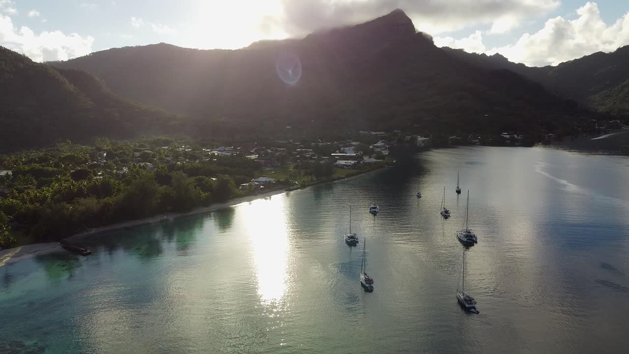 Lens flare aerial retreats from tropical Polynesian island village