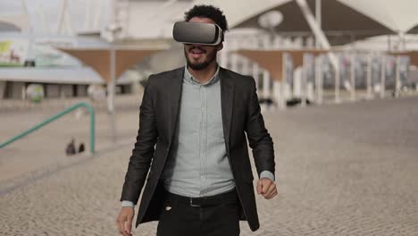 young middle eastern man wearing formal suit with vr glasses