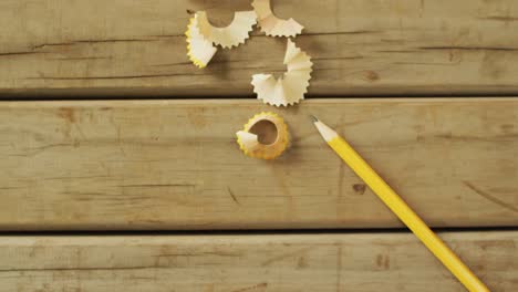 video of pencil and peels on wooden surface