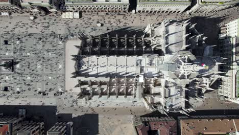 milan duomo cathedral church building with crowds of people - aerial overhead top down view