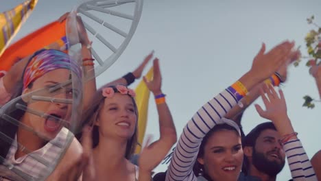 Dna-structure-spinning-against-group-of-people-clapping-together-at-a-concert