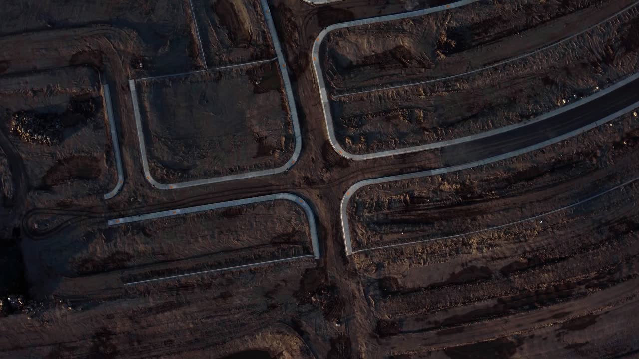 A top-down drone shot of the muddy roads at a construction site