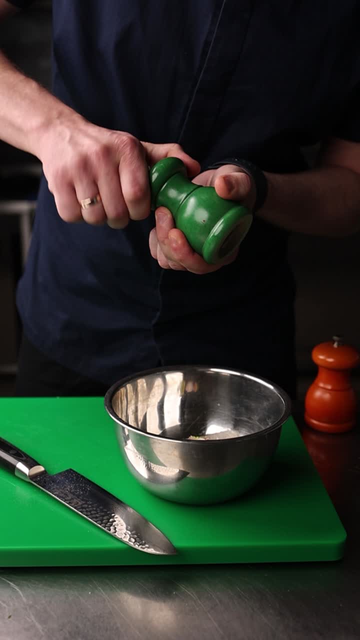 Chef Grinding Pepper Over Ingredients