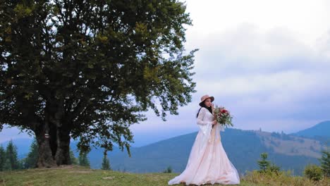 Beautiful bride on mountain. Wedding shot of young bride at mountains with amazing view