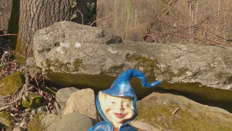 colorful miniature of elf with blue hat along invorio trail of elves in italy