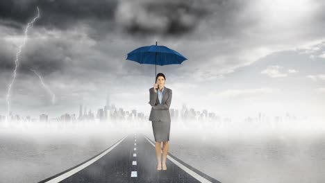 composite image of businesswoman holding an umbrella