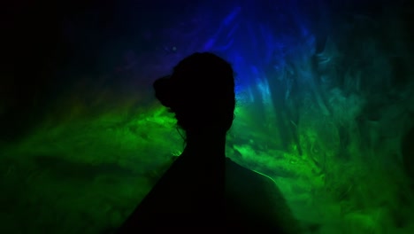 image of young girl on light background of different colors moving in the dark. smoke fills the triangle with the girl's head.