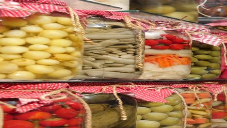 assorted pickled vegetables in glass jars