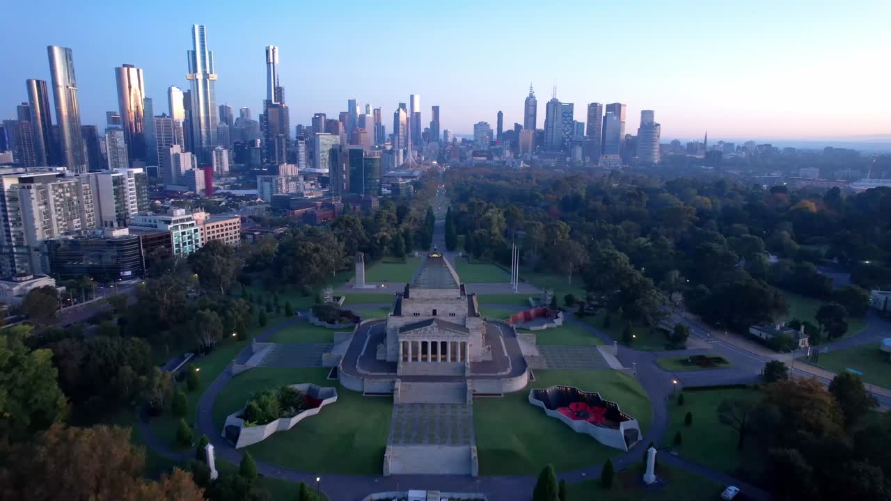 Aerial forward Shrine of Remembrance, war memorial and Melbourne sunrise Skyline
