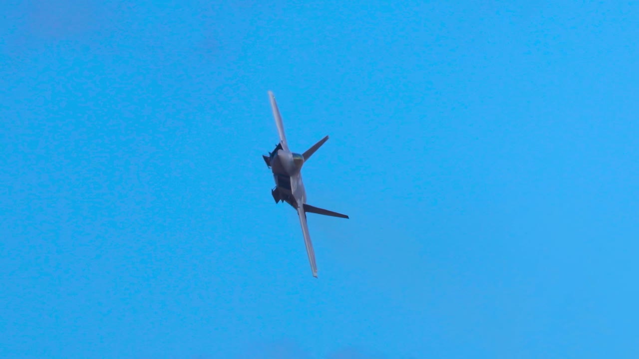F-22 Raptor performs dynamic aerial maneuvers against a clear blue sky, showcasing agility and speed in a 12-second sequence