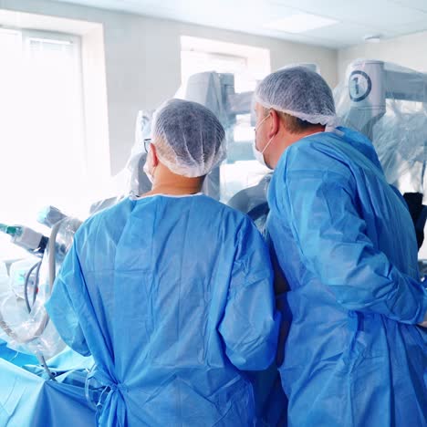 medical surgical robot, cancerous tumor removal surgery. modern medical equipment. minimally invasive robotic surgery . monitor shows procedure in background