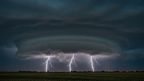 a powerful thunderstorm unfolds: captivating lightning strikes illuminate the sky beneath a dramatic storm cloud formation in a captivating display of nature's fury