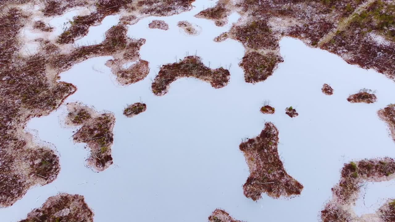 Aerial top down view of frozen Cena bog patterns showing icy winter textures