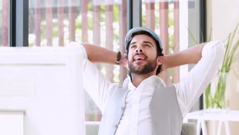 Happy-hipster-businessman-using-his-computer