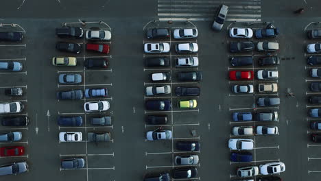 Drone-footage-cars-moving-at-parking.-Copter-view-people-leaving-car-at-parking