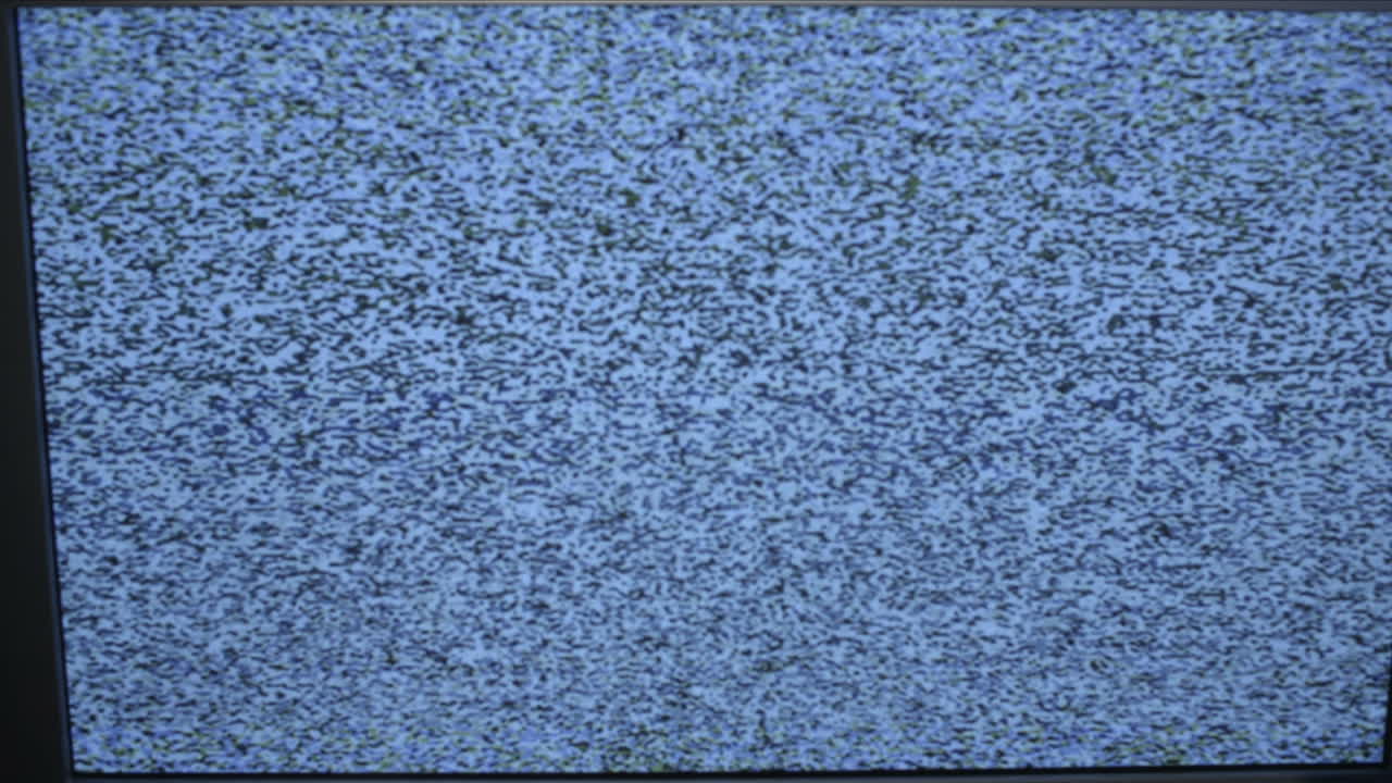 Tracking shot of TV screen with noise