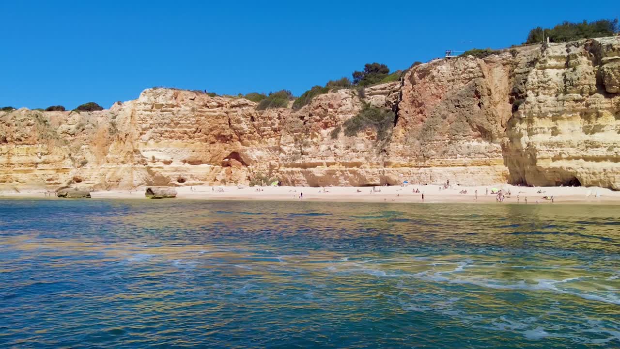 A 4K boat shot of Portugal's Algarve Beaches and sandstone cliffs make a striking scene