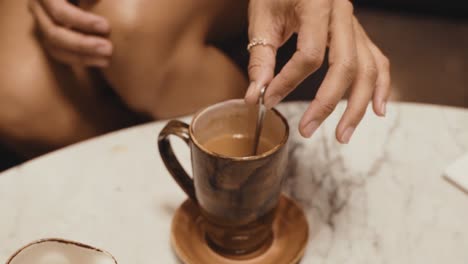 african american woman stirring coffee