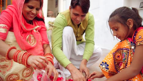 young parents with daughter celebrate decorate for diwali festival