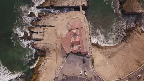 spectacular top-down view of a coastal landscape with rocky shores, ocean waves, and a winding road. perfect for travel blogs, editorial use, or digital backgrounds.