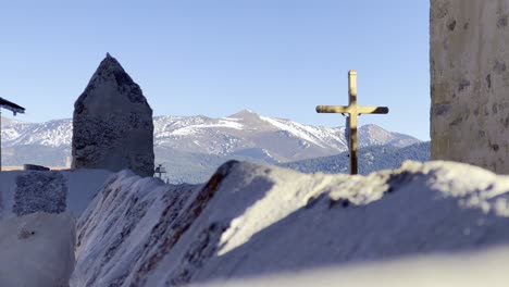 A static frame with a crucifix in a mountainous area in winter
