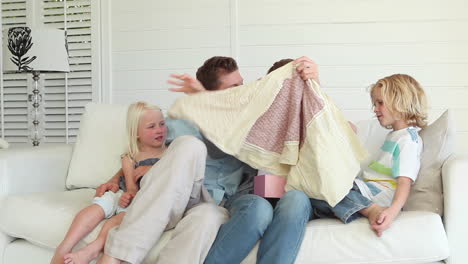 woman opening a gift and thanking her family