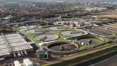 Aerial-shot-flying-over-a-sewage-processing-plant-in-Edinburgh-as-seagulls-fly-around