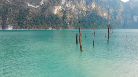 Flying-Around-The-Squeaky-Clean-Water-Of-Serene-Lake-In-Khao-Sok-National-Park,-Surat-Thani,-Thailand-Surrounded-By-Limestone-Cliffs